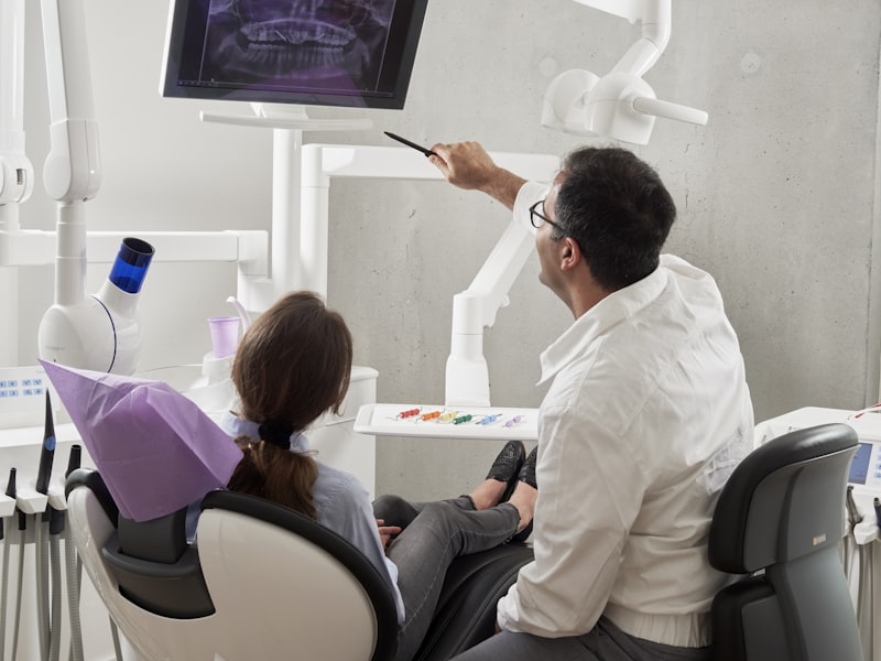 Dental surgeon examining patient teeth